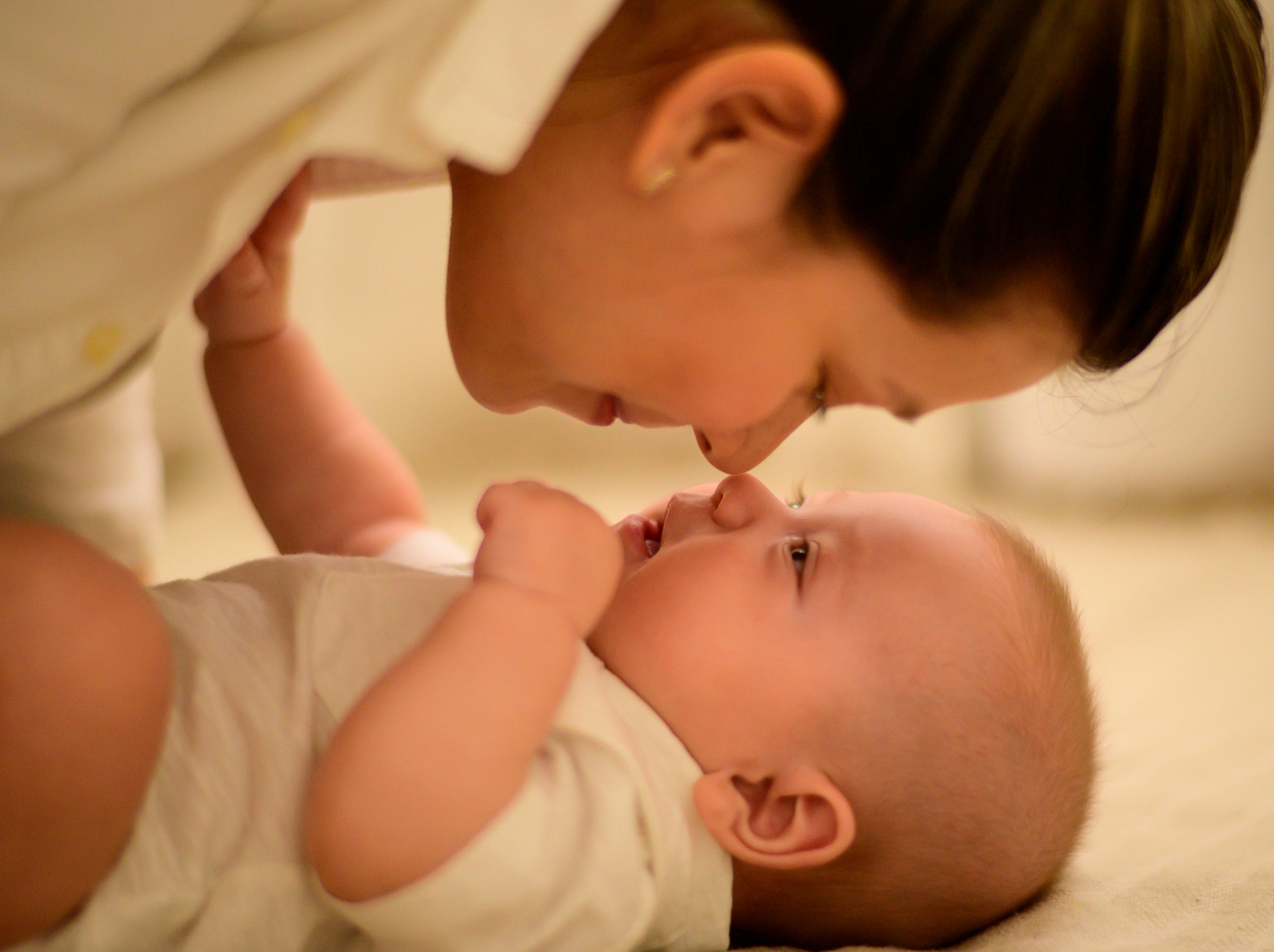 Mother and baby in a tender, dimly-lit moment